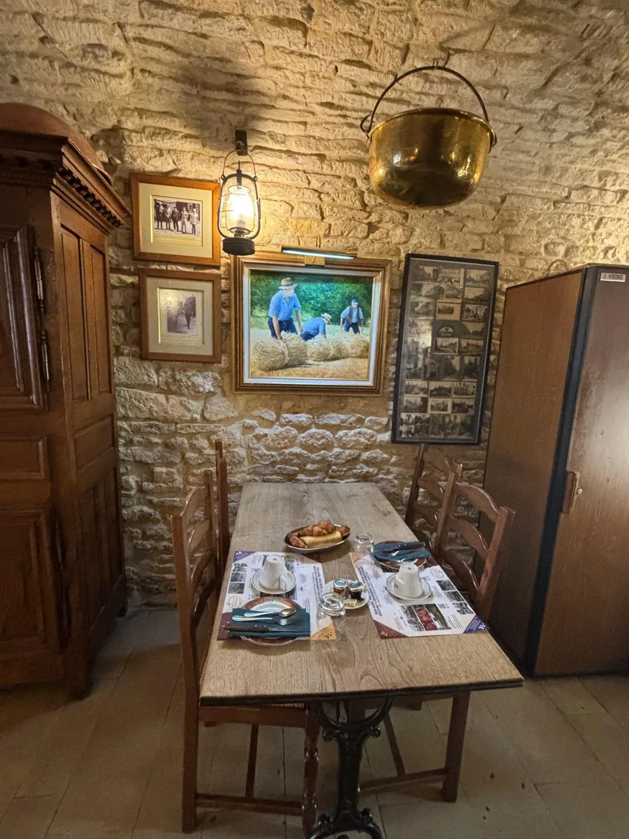 The breakfast room with oil lantern, harvest painting and old photographs