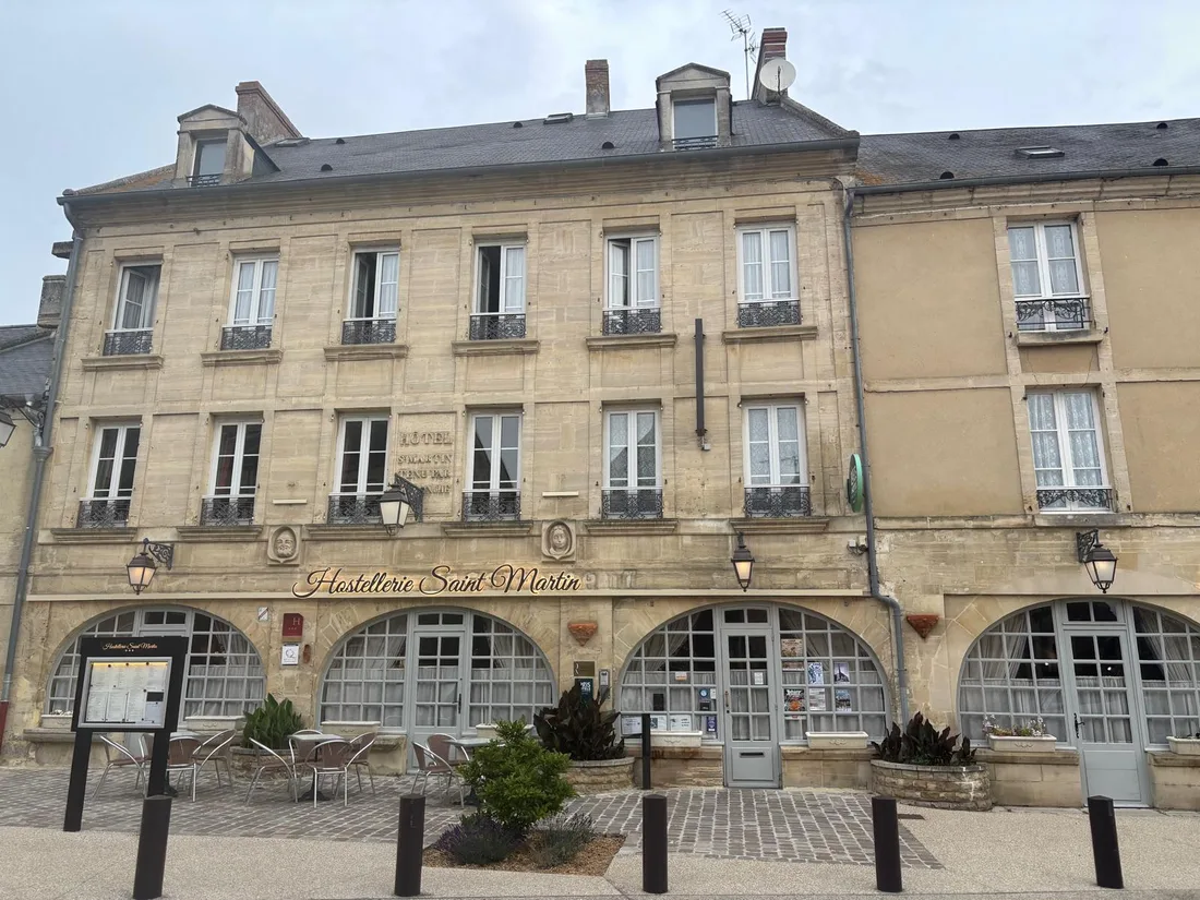 The honey-stone facade of the Hostellerie Saint-Martin on the village square