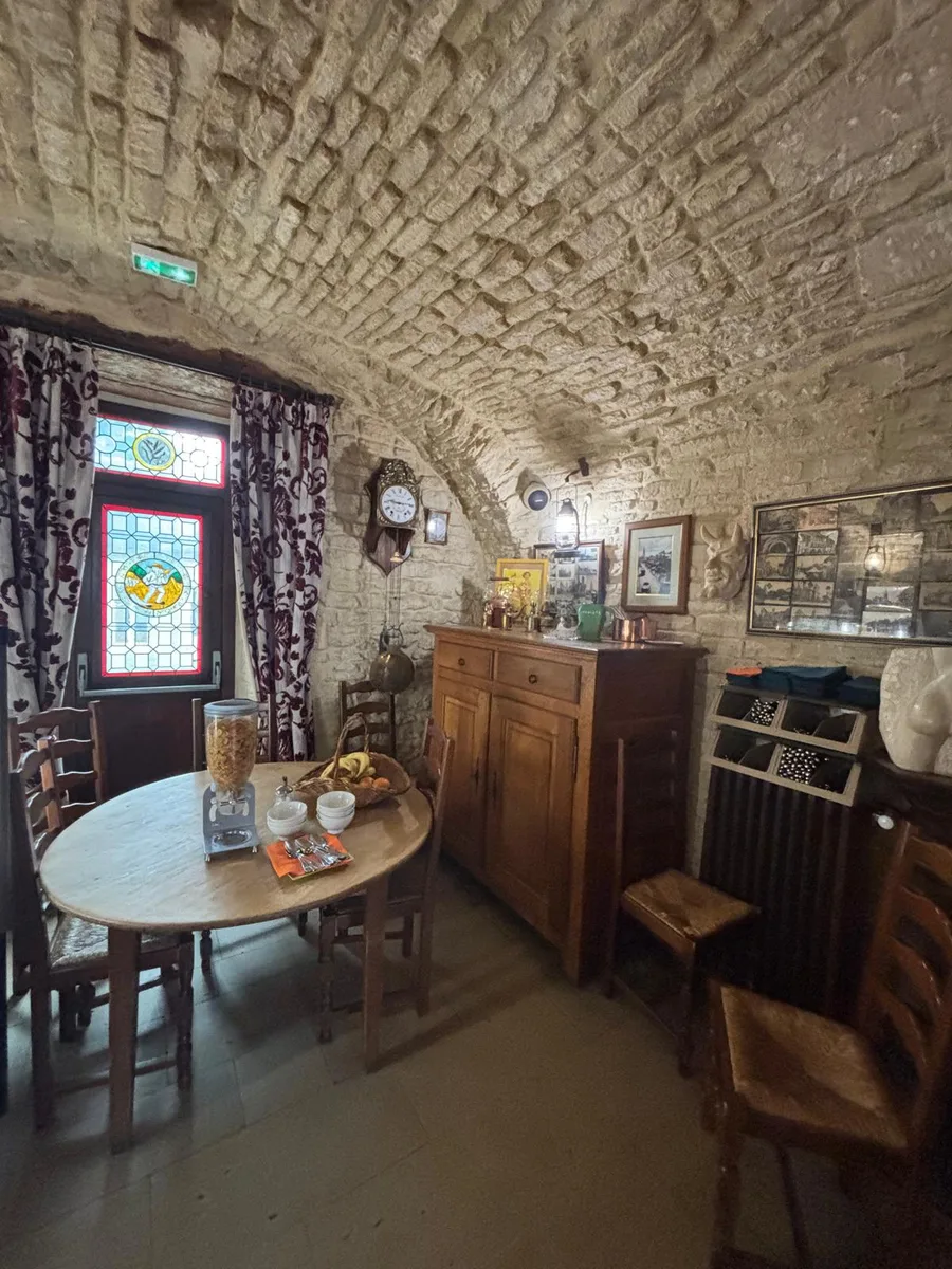 A room with stained glass window, grandfather clock and breakfast buffet